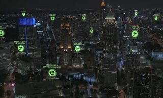 Cityscape at night with green glowing crime alerts dotting the town