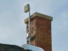 Photo of a ShotSpotter acoustic surveillance device attached to a chimney.