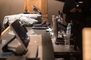 A police cap sitting on a bar next to beer taps.