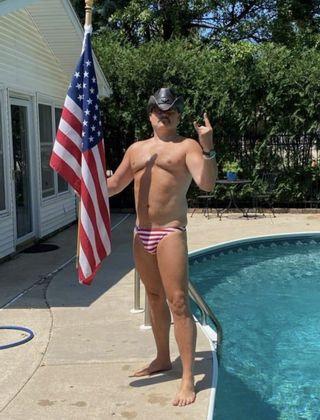 Martin Tully with flag by pool; Source: Facebook