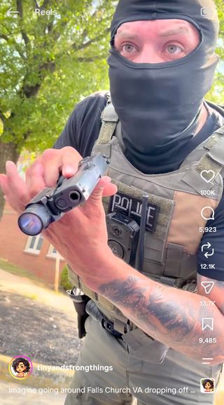 close up screengrab from Instagram video of masked man with arm tattoo pointing gun